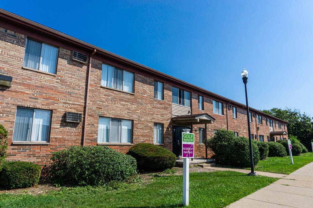 Exterior of apartment entrance at resident only parking at Golf Manor Apartments in Roseville, Michigan