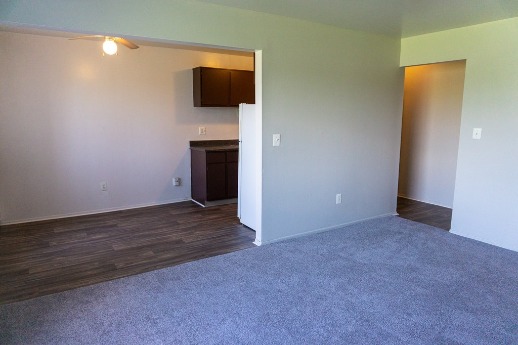 Spacious living room and dining room at Golf Manor Apartments in Roseville, Michigan