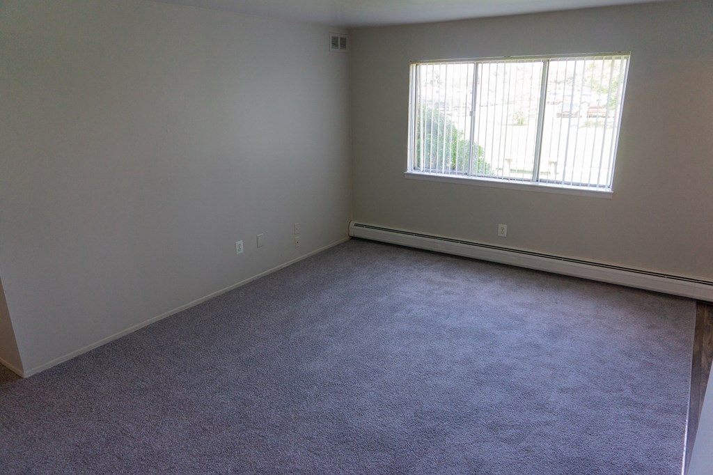 Spacious living room at Golf Manor Apartments in Roseville, Michigan