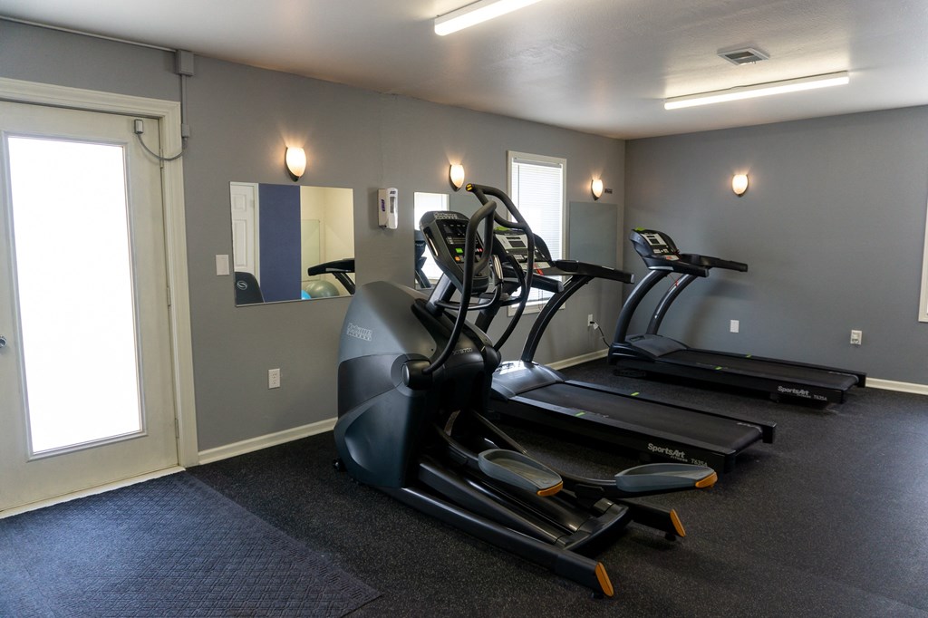a room with a treadmill and a mirror