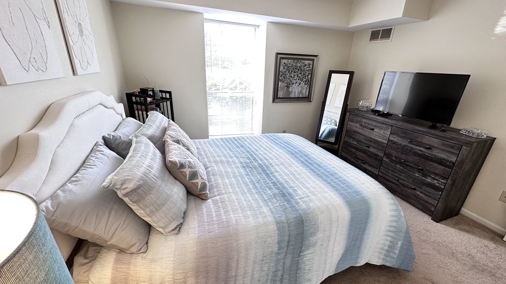 a bedroom with a large bed and a tv