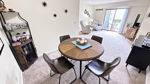 a dining room with a table and chairs and a living room