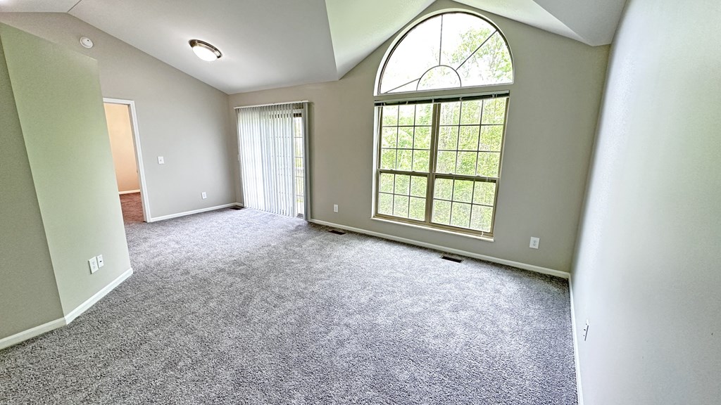 an empty living room with a large window