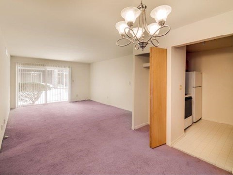 a living room with a purple carpet and a chandelier