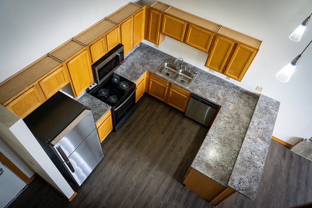 an overhead view of a kitchen with wooden cabinets