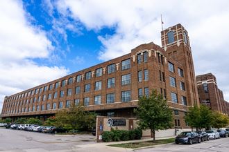 a large brick building with a clock tower - Photo Gallery