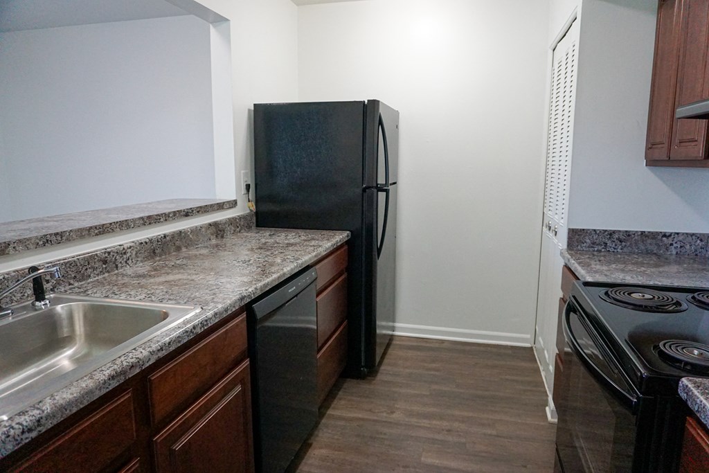 Fully Equipped Kitchen with granite counter tops at Woodcrest Apartments in Westland, Michigan
