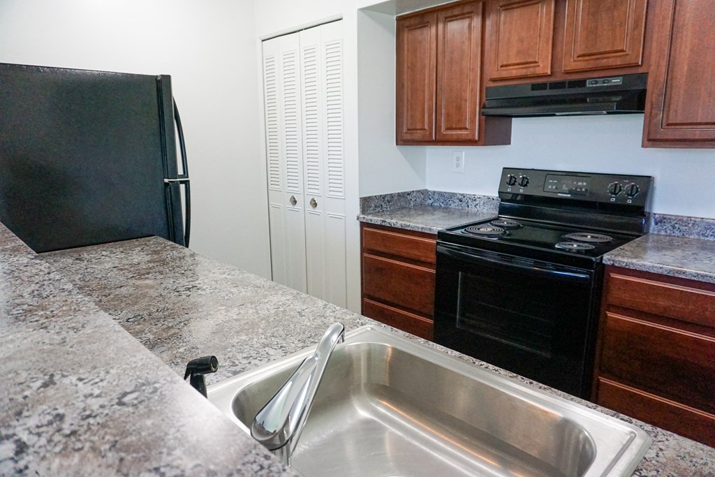 Fully Equipped Kitchen with granite counter tops at Woodcrest Apartments in Westland, Michigan