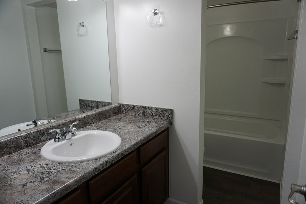 Bathroom with granite countertops at Woodcrest Apartments in Westland, Michigan