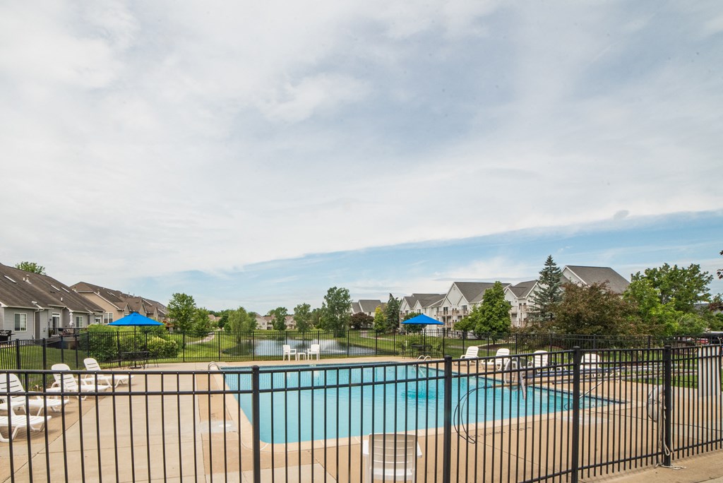 Swimming Pool and pool chair at Cambridge Club Apartments in Ann Arbor, Michigan