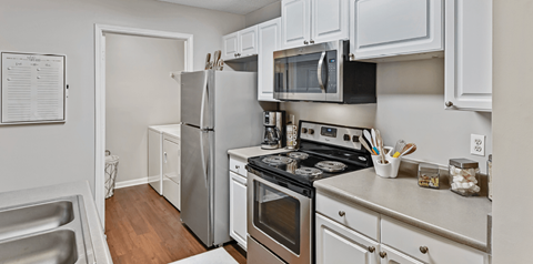a kitchen with stainless steel appliances and white cabinets
