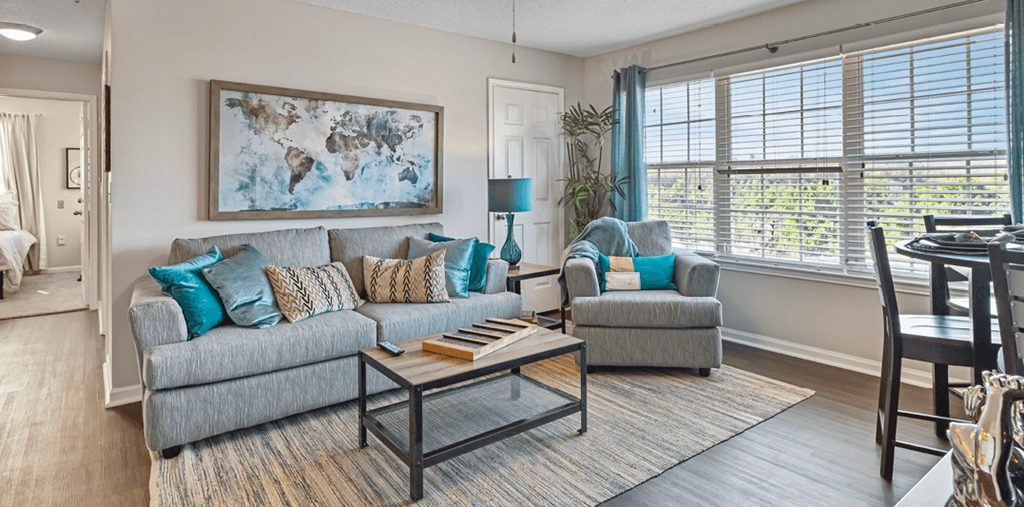 a living room with a couch and a chair and a table