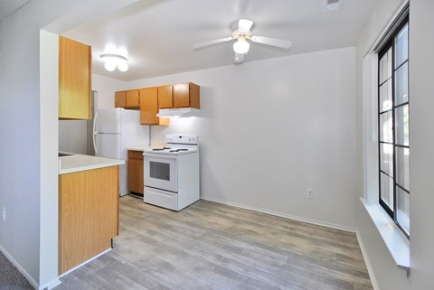 A kitchen with a refrigerator, oven, and microwave.