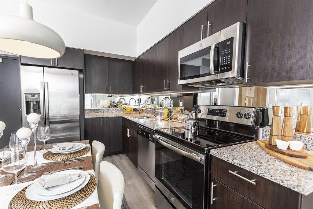 a kitchen with stainless steel appliances and a dining table