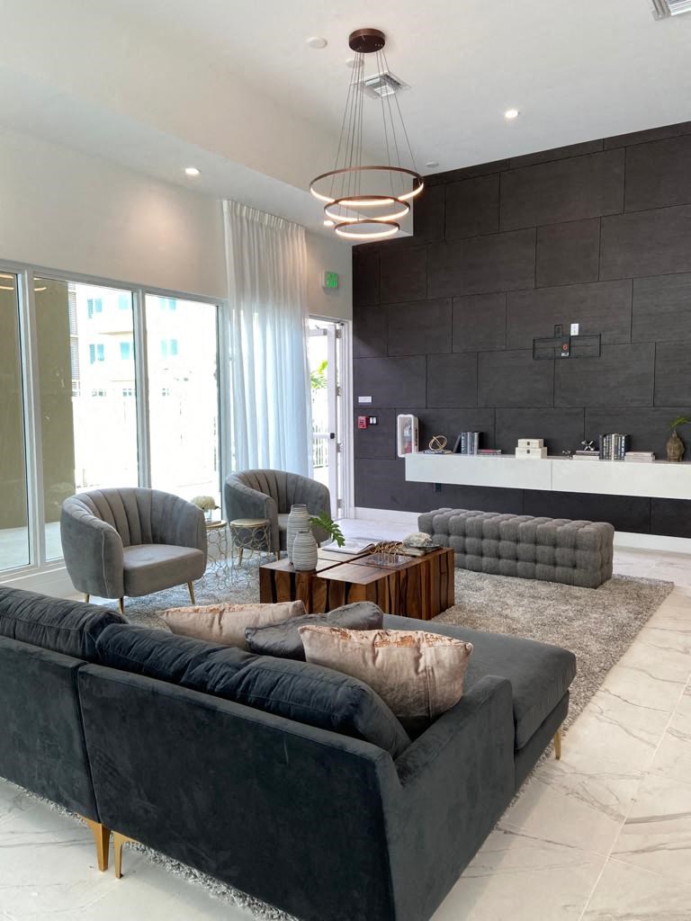 a living room with a couch and chairs and a table