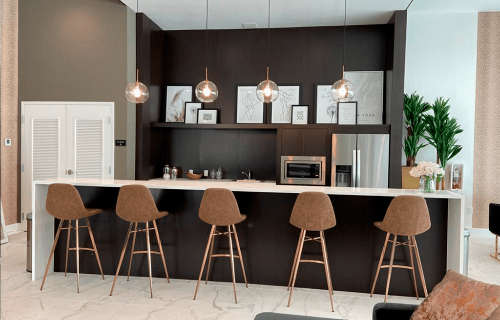 a kitchen with brown bar stools and a counter top