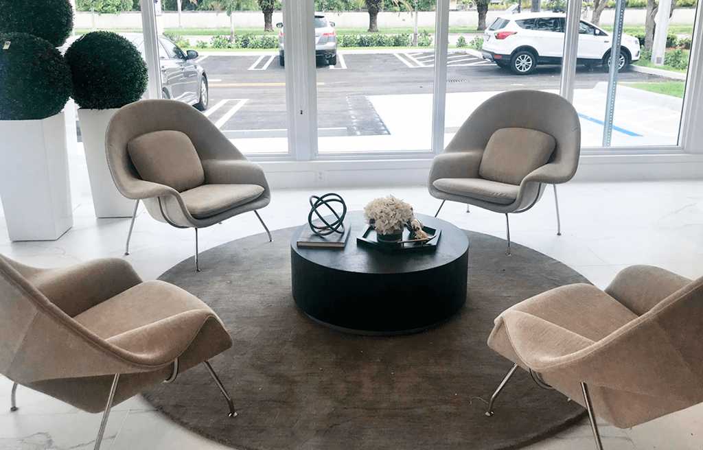 a group of chairs around a coffee table in a lobby
