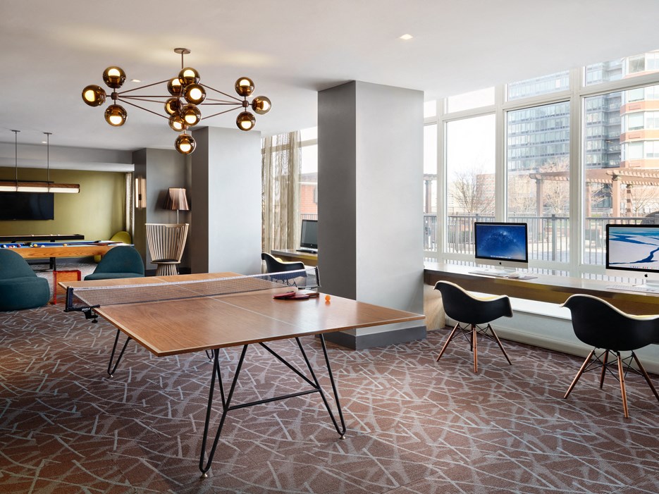 A conference room with a long table and chairs.