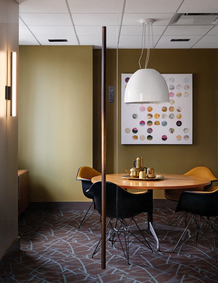 A dining room with a table set for two.