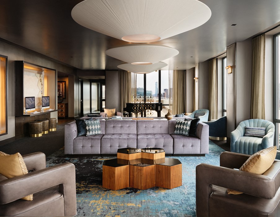 A modern living room with a grey sofa and a wooden coffee table.