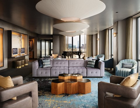 A modern living room with a grey sofa and a wooden coffee table.