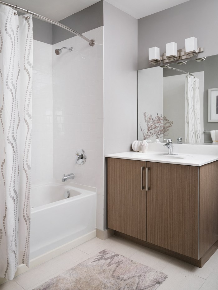 a bathroom with a shower and a sink and a mirror