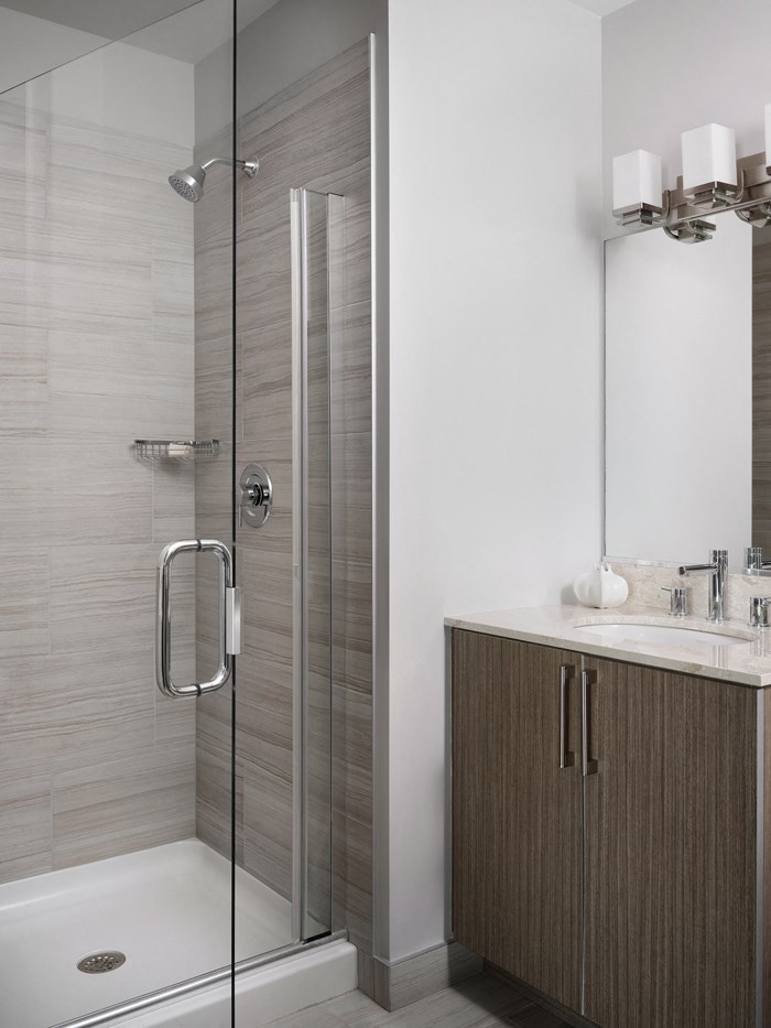 a bathroom with a shower and a sink and a mirror