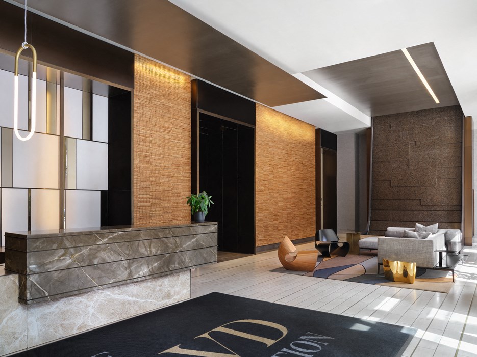 a lobby with a black rug and a reception desk