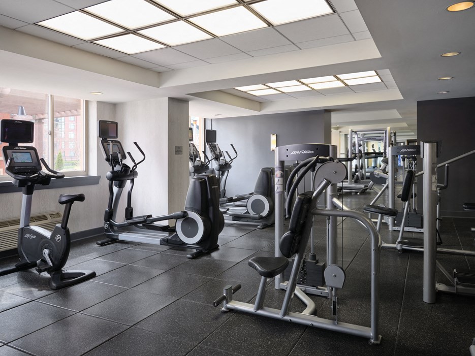 a row of exercise equipment in a gym