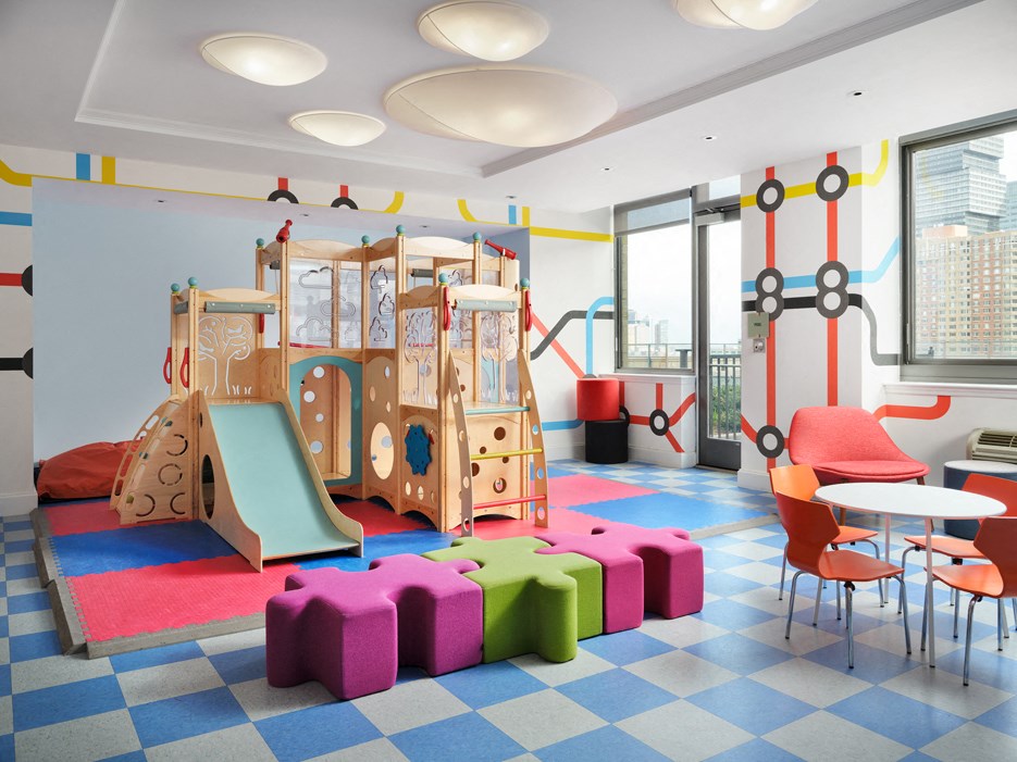 A play area with a slide, a climbing frame and a table.