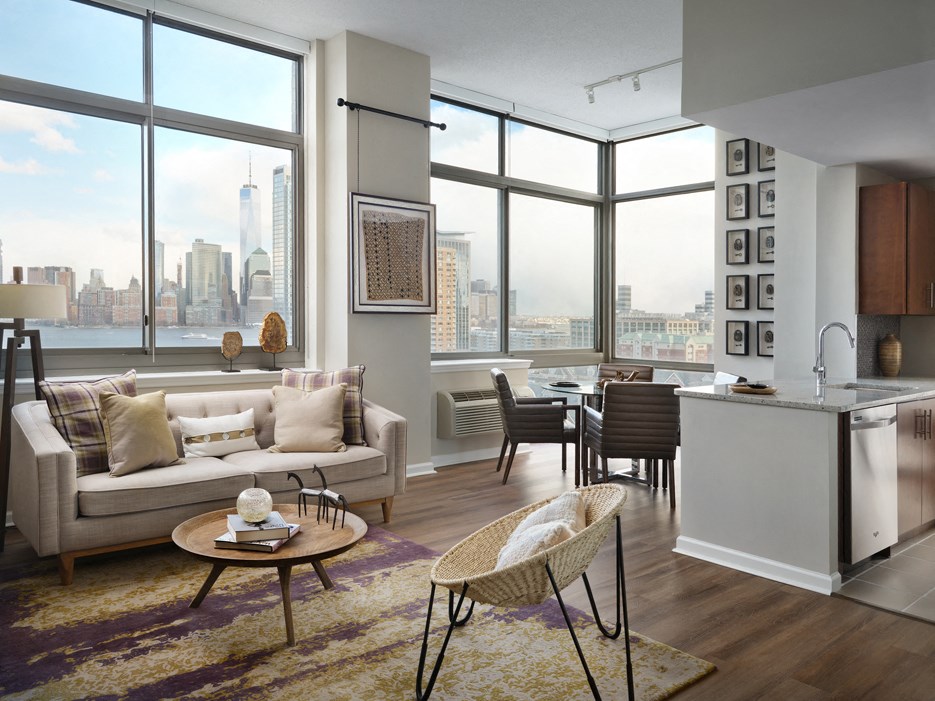a living room and kitchen with a view of the city