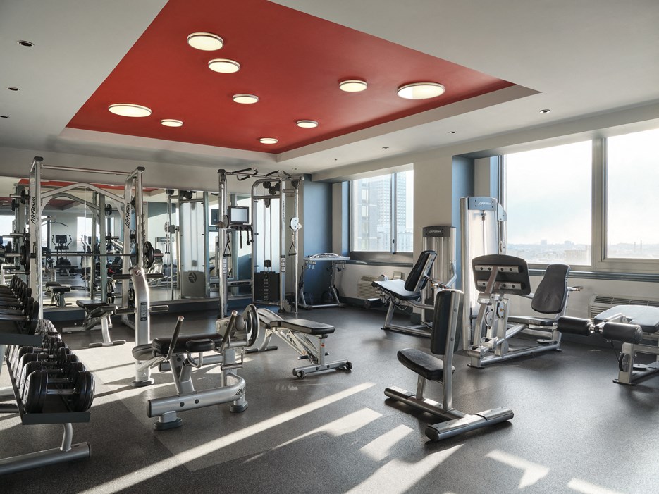 A gym with a red ceiling and various exercise equipment.