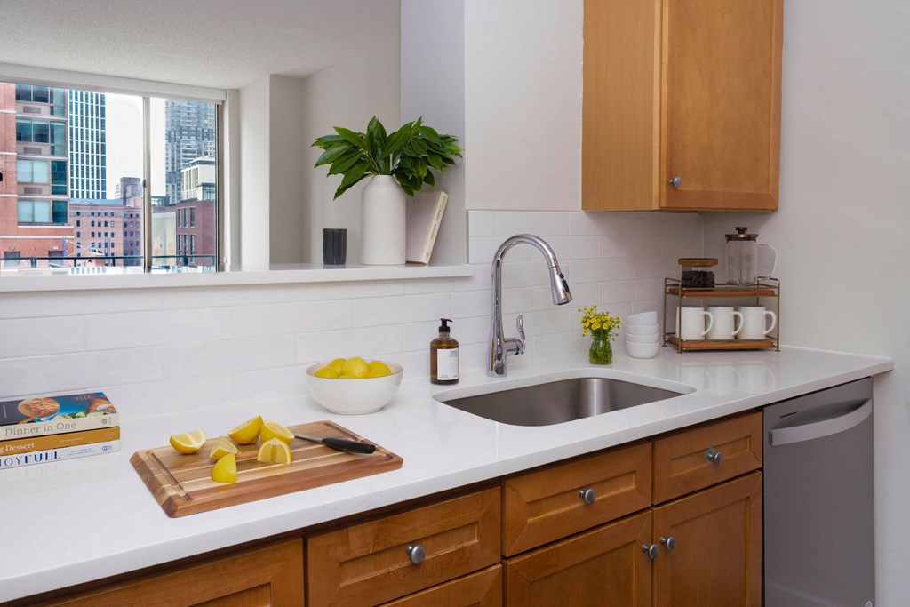 A kitchen with wooden cabinets and a white countertop.