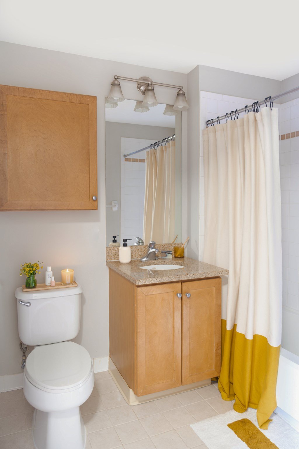 A bathroom with a toilet, sink, and shower curtain.
