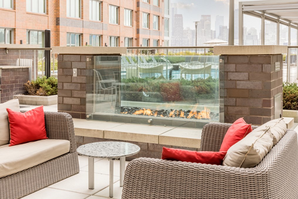 an outdoor patio with chairs and a fire pit
