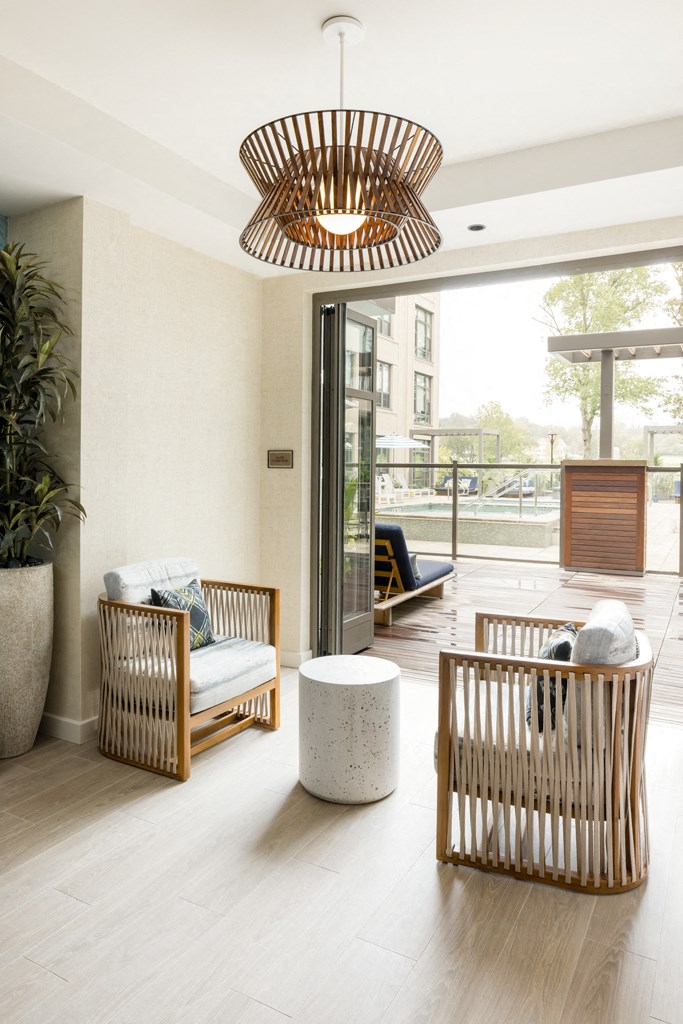 a living room with two chairs and a table and a chandelier