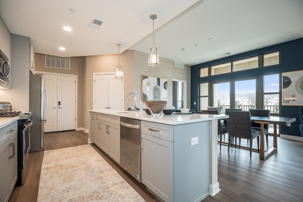 an open kitchen and dining room with a large island