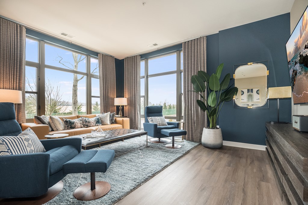 a living room with blue walls and large windows