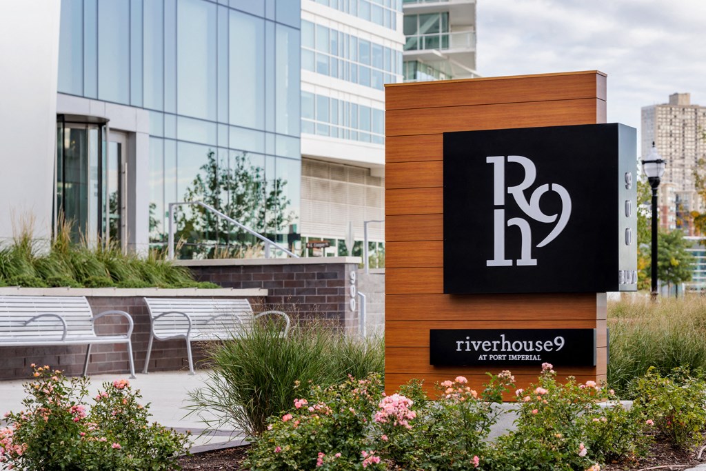 a sign outside of a building with a table and chairs