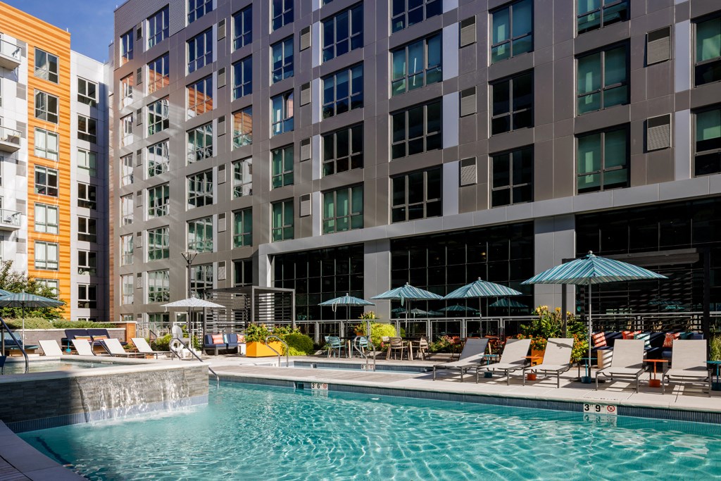 a swimming pool in front of a tall building