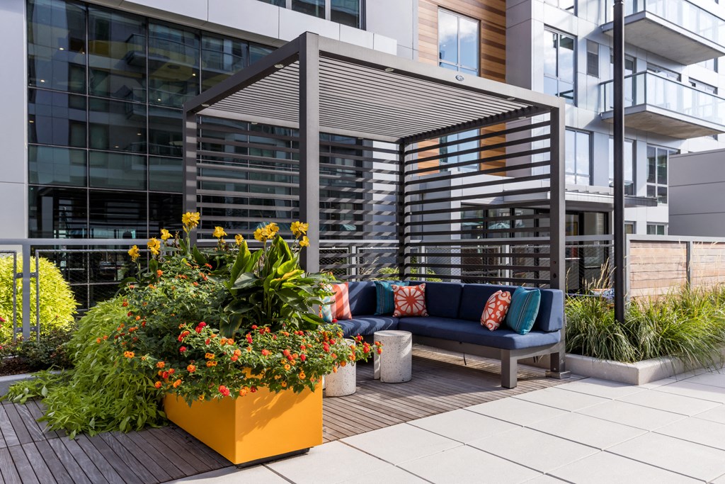 an outdoor patio with a couch and plants