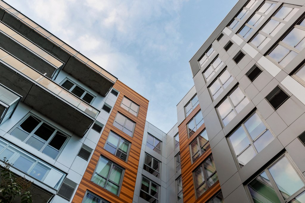 a row of apartment buildings against a blue sky