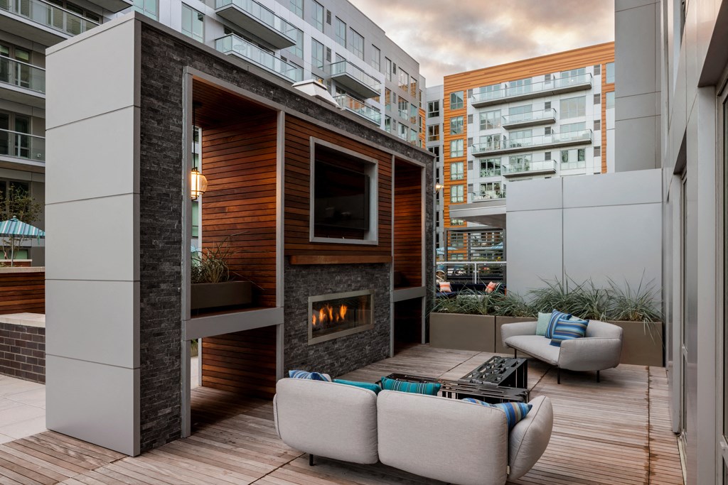 a living room with a fireplace and a balcony