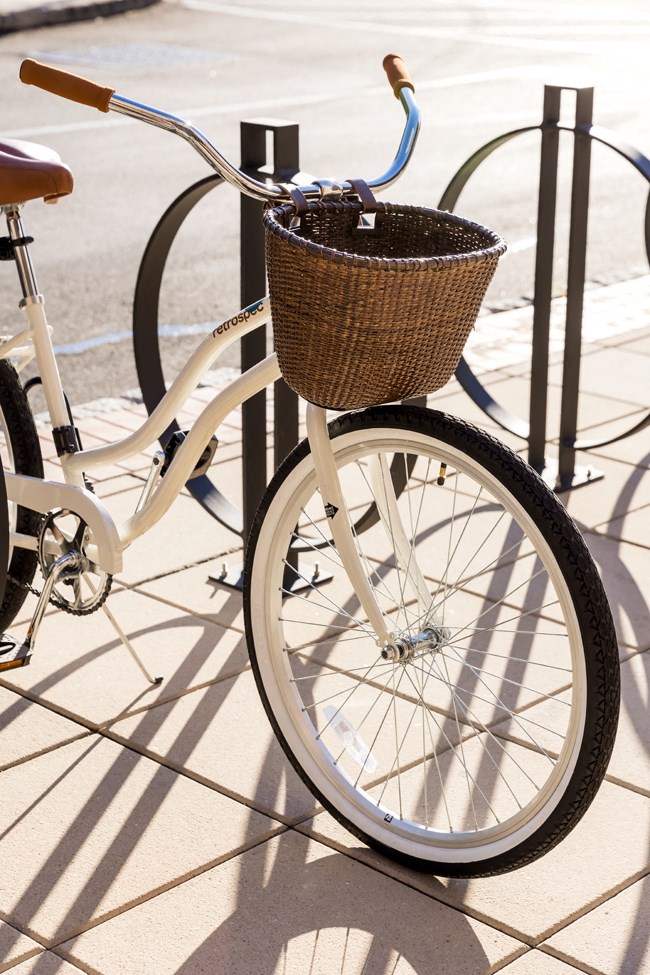 a white bike with a basket on the front