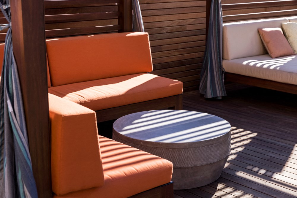 a deck with couches and a table on a boat