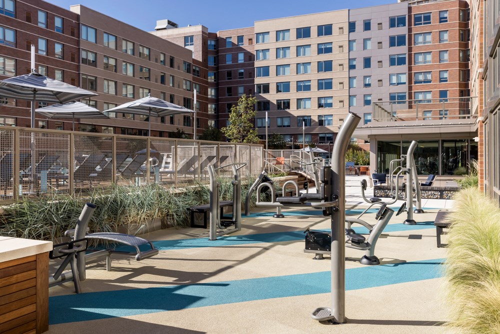 a gym with a lot of exercise equipment and buildings