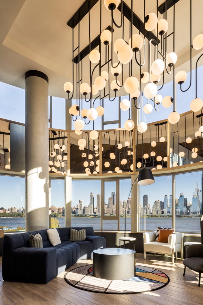 a rendering of a living room with large windows and a large chandelier