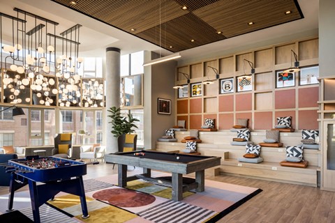 a living room filled with furniture and a pool table