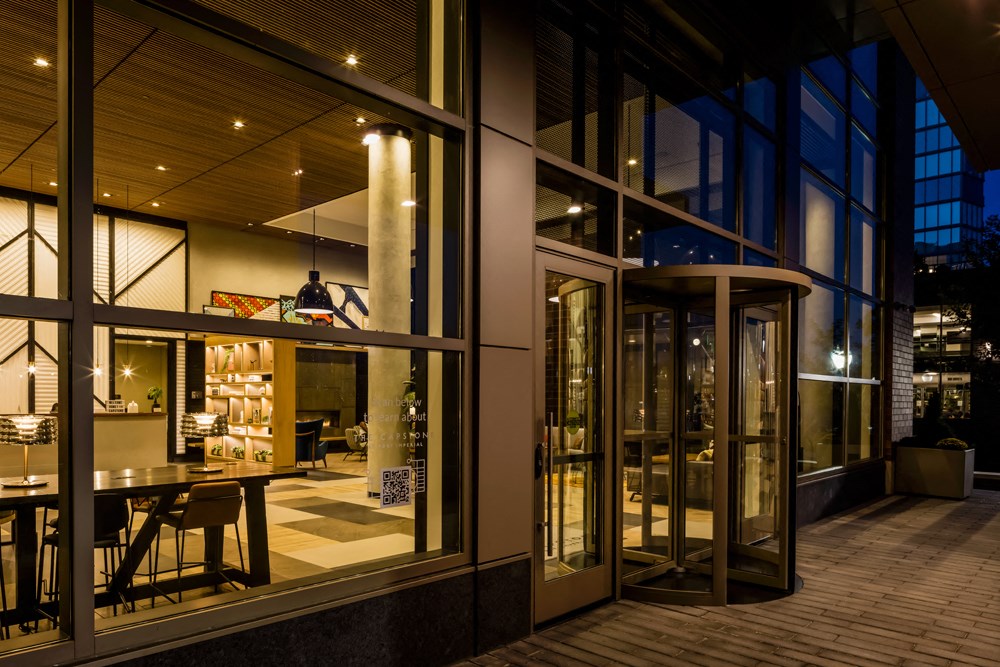 a restaurant with large glass windows at night