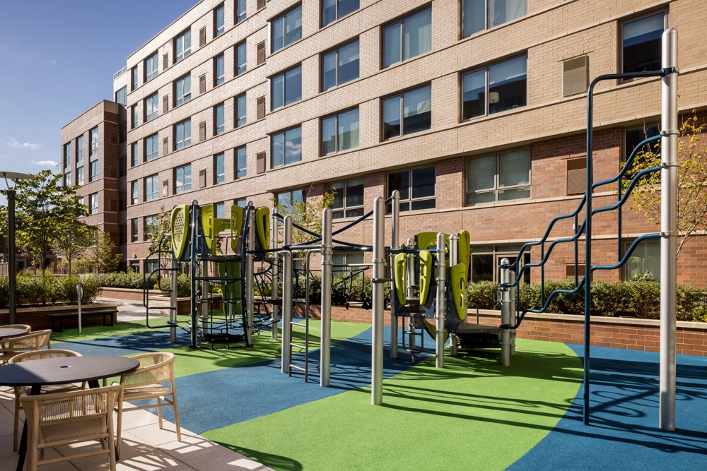 a playground in front of an apartment building